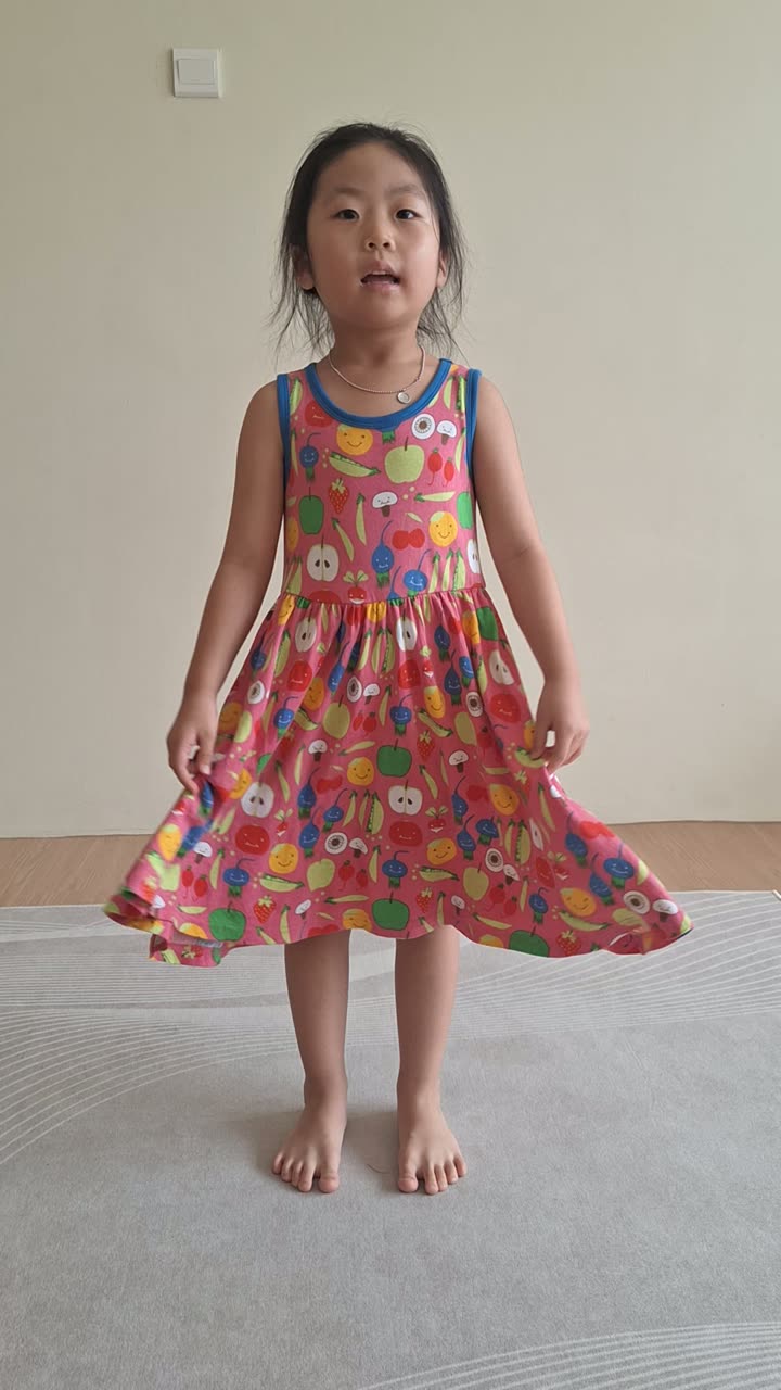 A young girl standing tall as she performs in front of the class