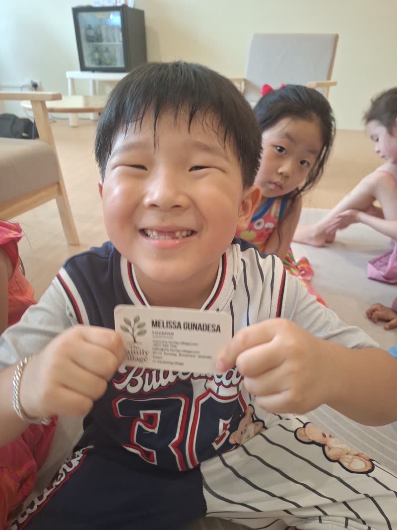 Boy smiling and holding his speech card