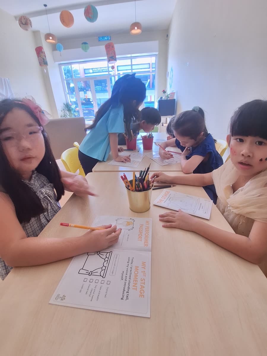 Children working on a script at the table